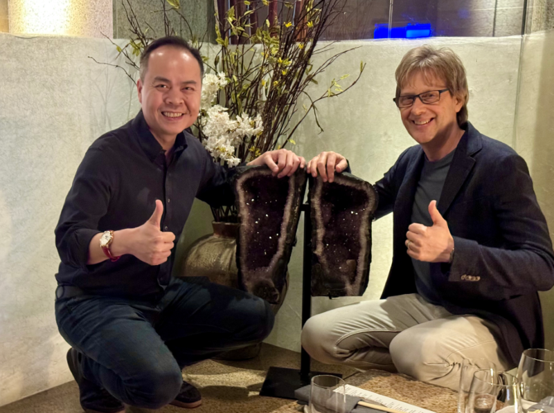 Jack Huynh and Mark Cerny holding a Amethyst crystal