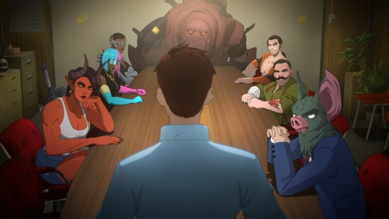 A guy staring standing at the head of the table staring at other creatures