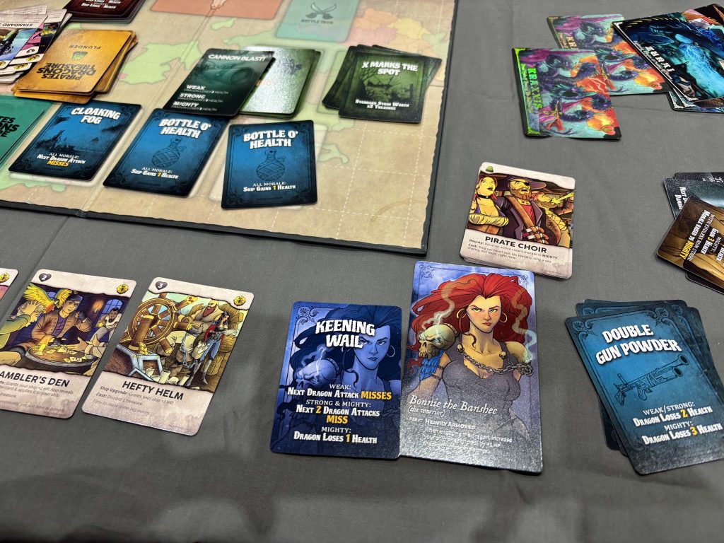 Pirates Dragons Treasure game-play cards on the game board on top of a gray tablecloth