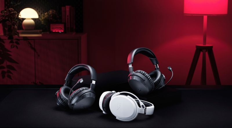 HyperX Clound Stinger headsets on black table with backdrop with red light in the corner
