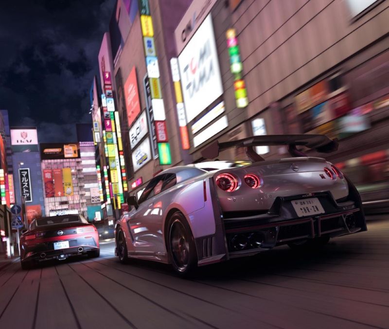 Nissan GTR driving on a tight road in Tokyo at anight with illuminated neon signs