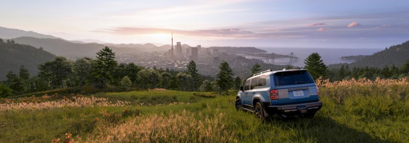 Toyota Prado Land Cruiser overlooking Tokyo City District on a grassy hill