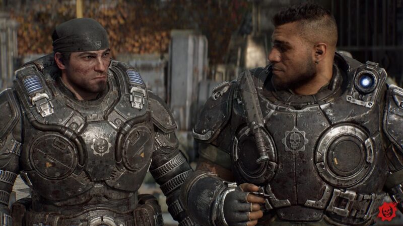 Marcus and Dom sitting side by side looking at each other